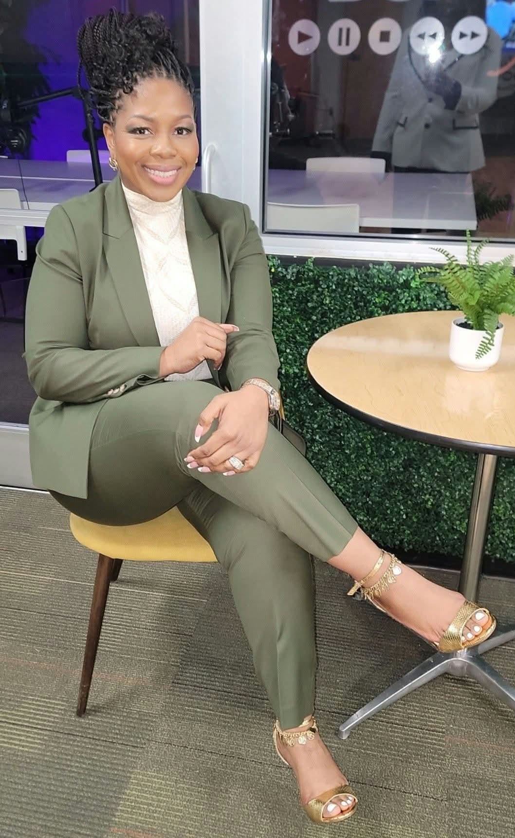 Coach C, Charmian Stephens, smiling in an olive suit